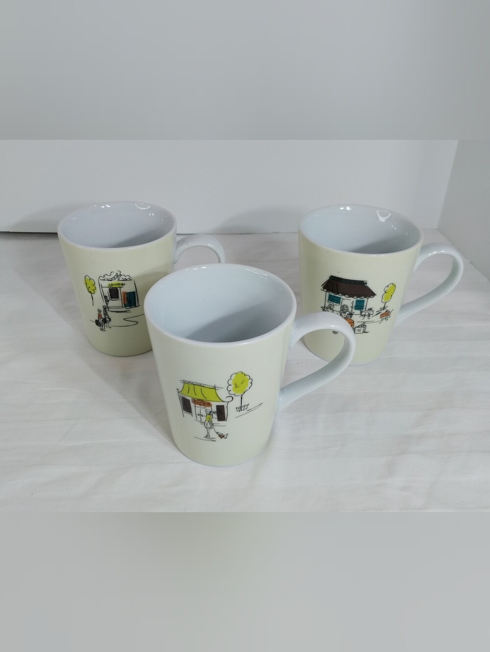 Three 2003 Boston Warehouse Trading Corp Parisian ceramic mugs